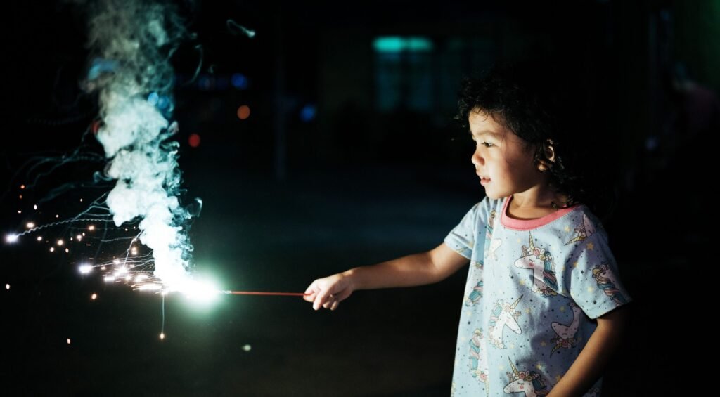 Kid celebrating festival using safe firecrackers for kids
