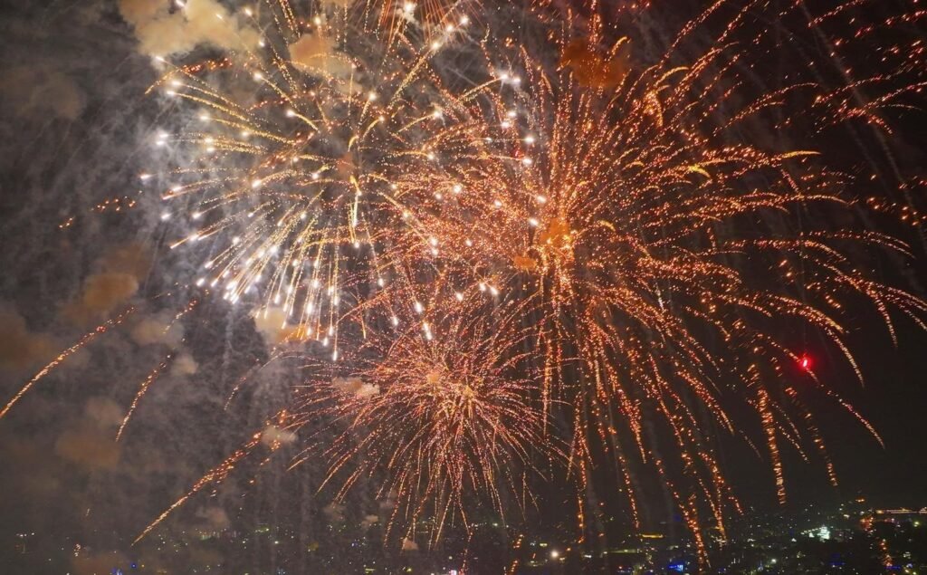 Fireworks bursting in the night sky during a festive celebration