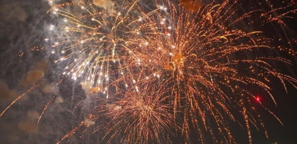Fireworks bursting in the night sky during a festive celebration